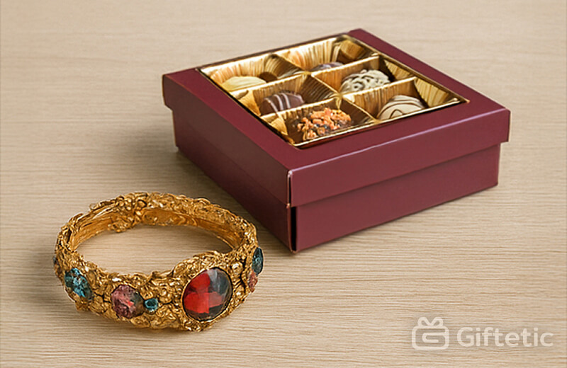 Luxury gold bracelet next to a box of chocolates — showing how mismatched gifts create awkward impressions.
